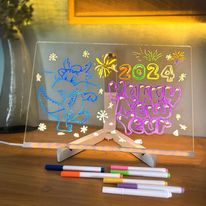 Decorative acrylic panel with colorful text and graphics, including '2024 Happy New Year', on a wooden surface with markers.