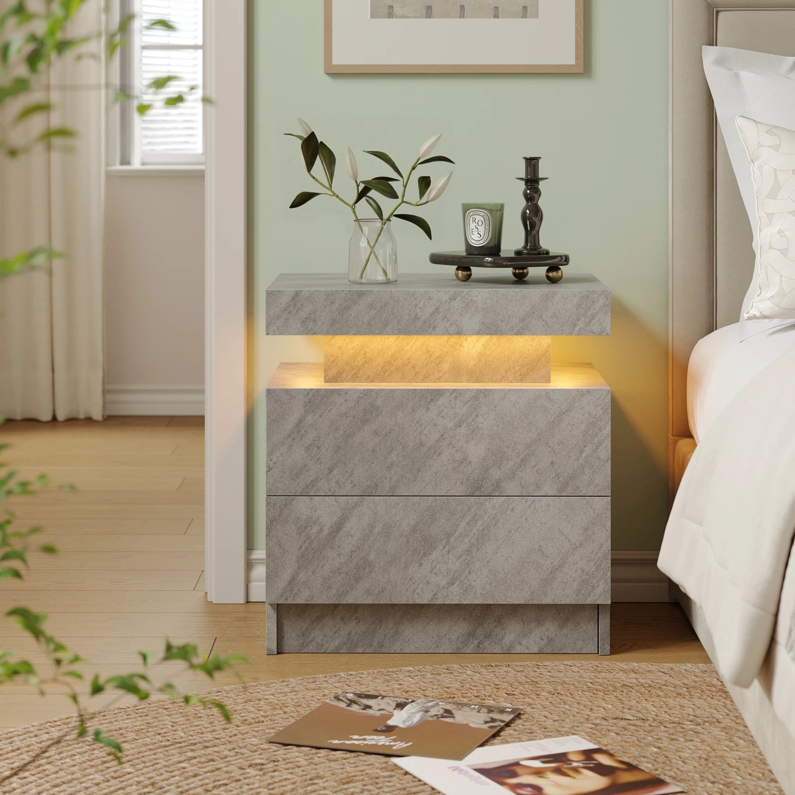 Gray marble nightstand with decorative items in a bedroom setting