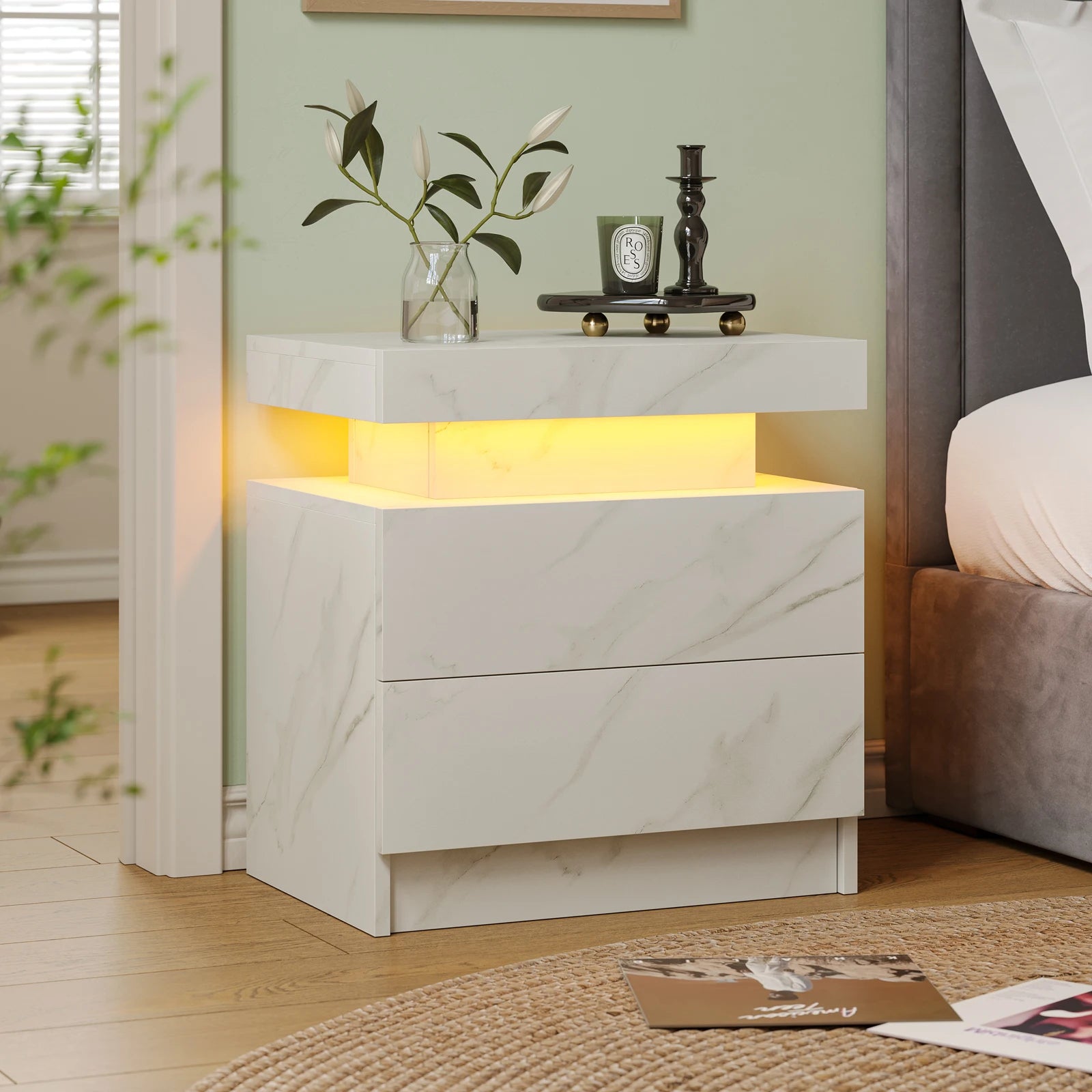 Modern nightstand with marble design and LED lighting in a bedroom setting.