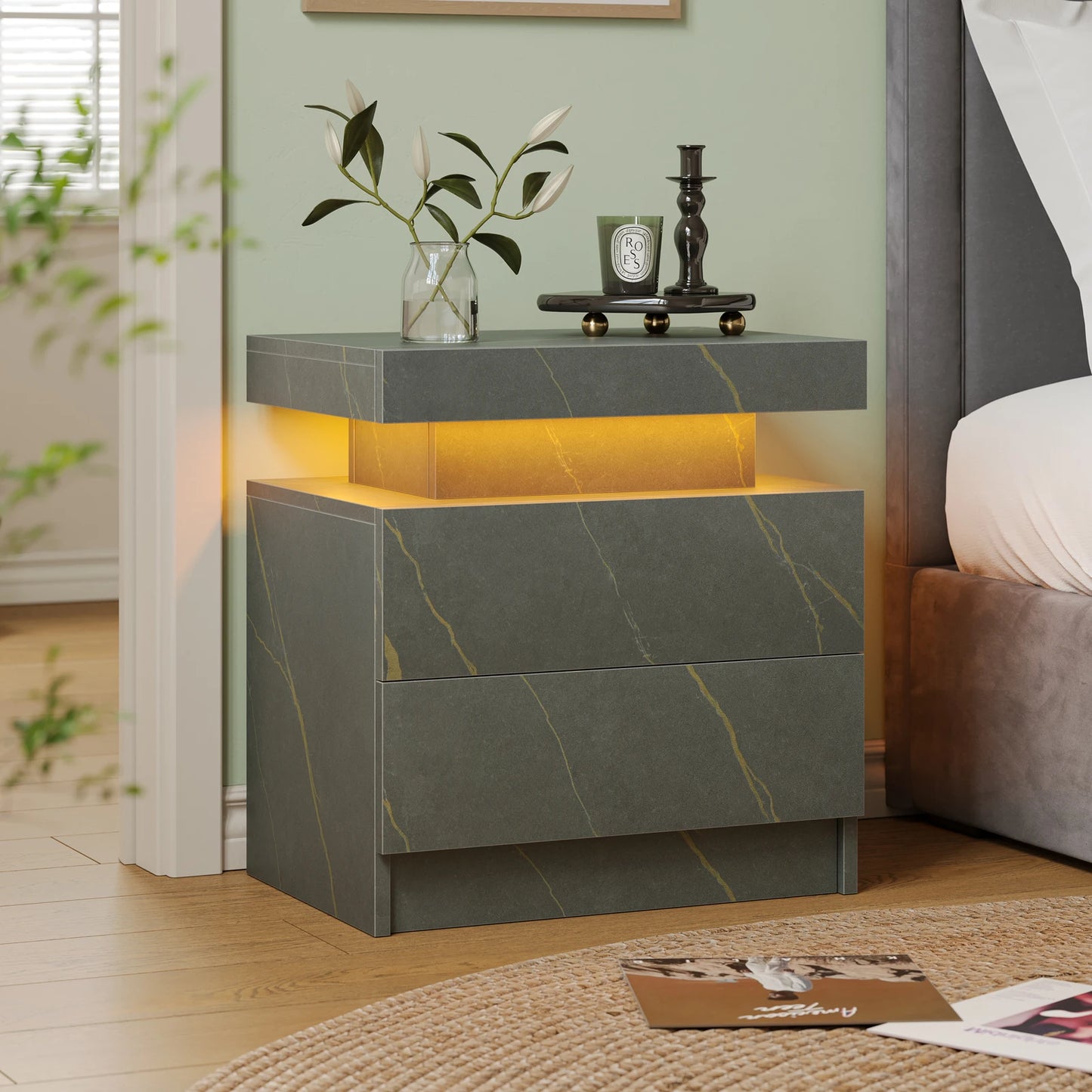 Modern nightstand with marble-like design and LED lighting in a bedroom setting.