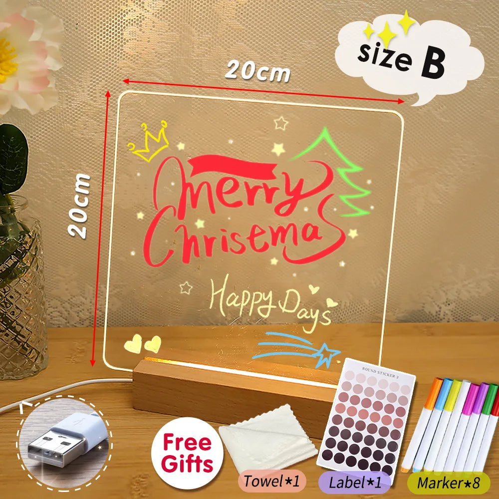 Decorative LED sign with 'Merry Chrisema' text, markers, and free gift items on a wooden surface.