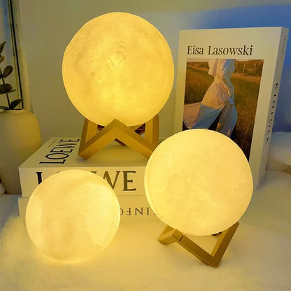 Three moon-shaped lamps on stands with a book titled 'Eisa Lasowski' in the background.