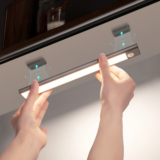 Hands holding a strip light fixture with a neutral background
