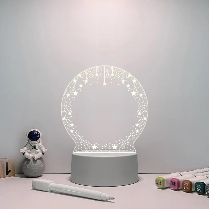 Decorative night light with stars on a table next to stationery items.