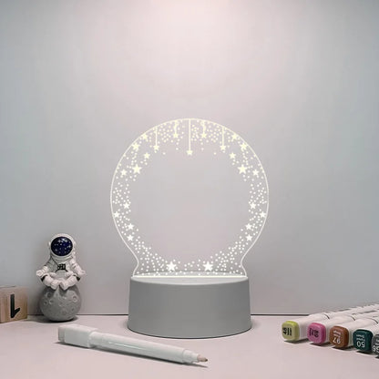 Decorative night light with stars on a table next to stationery items.