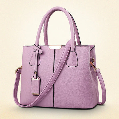 Purple handbag with a strap on a beige background