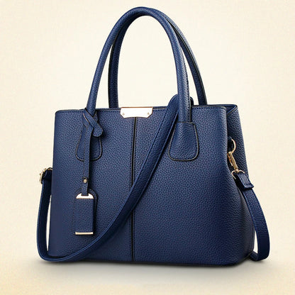 Blue handbag with a strap on a beige background