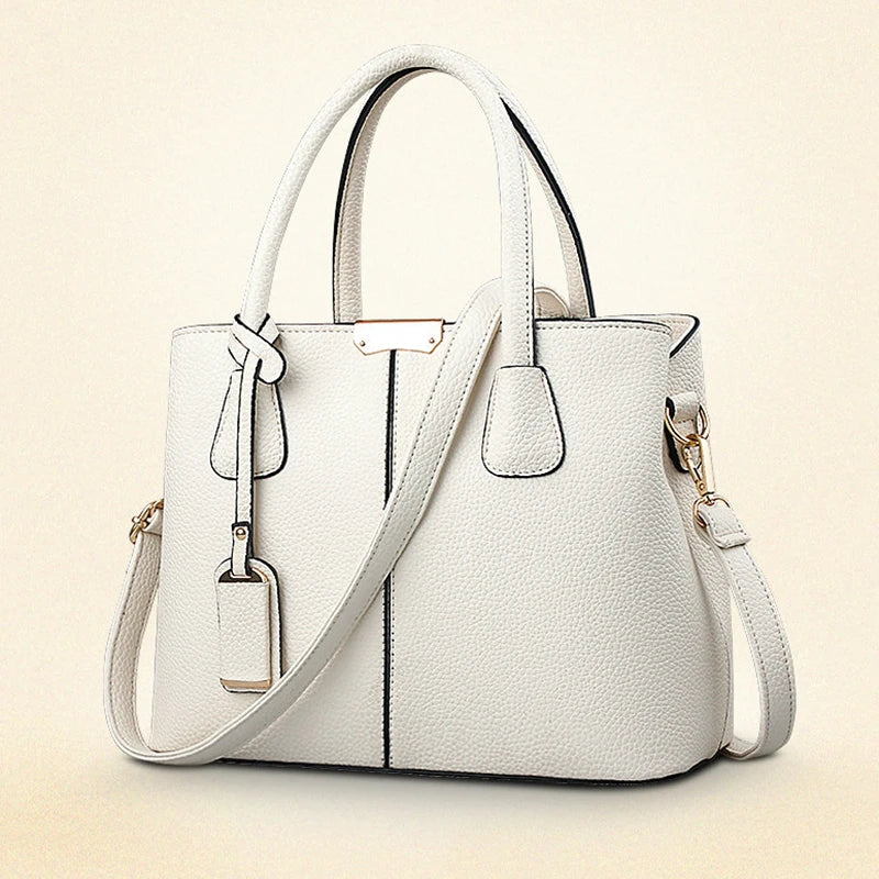 White handbag with a strap on a beige background