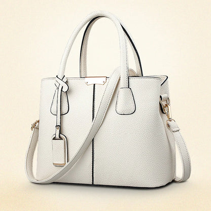 White handbag with a strap on a beige background