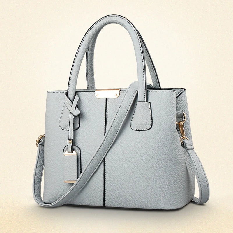 Light blue handbag with a shoulder strap on a beige background
