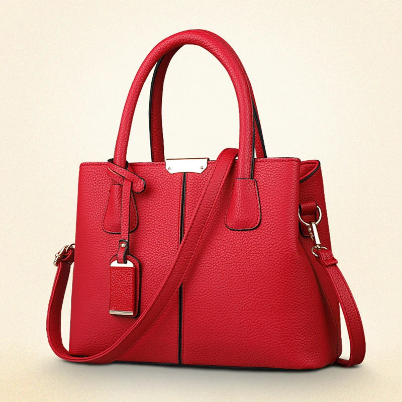 Red handbag with a shoulder strap on a beige background