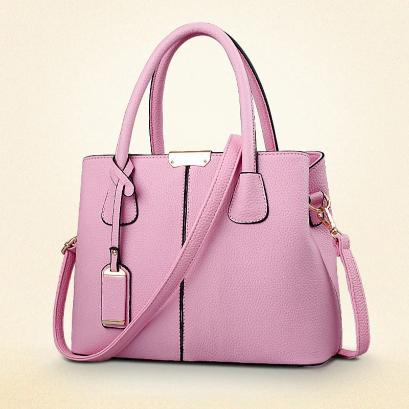 Pink handbag with a strap on a light beige background