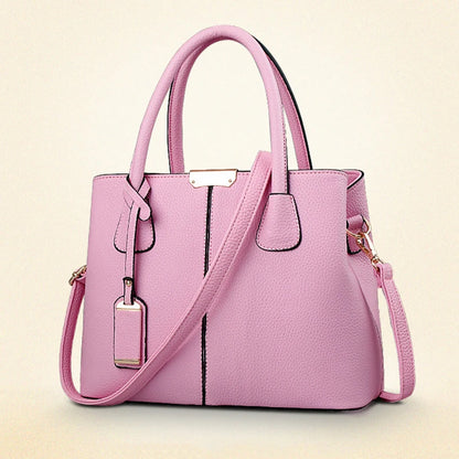 Pink handbag with a strap on a light beige background