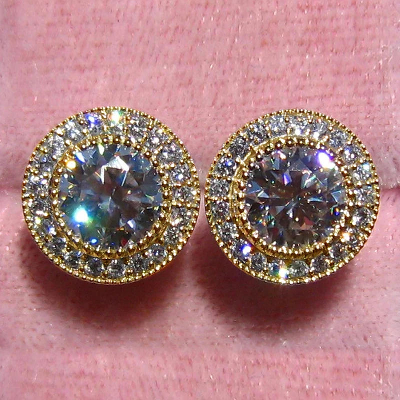 Gold and diamond earrings on a pink background