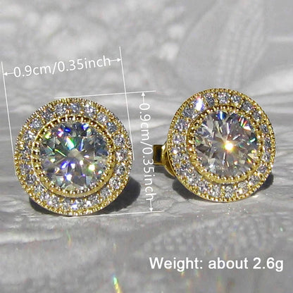 Gold and diamond earrings with measurements and weight information on a reflective surface.