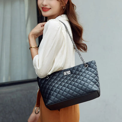 Woman holding a black quilted handbag with a blurred background