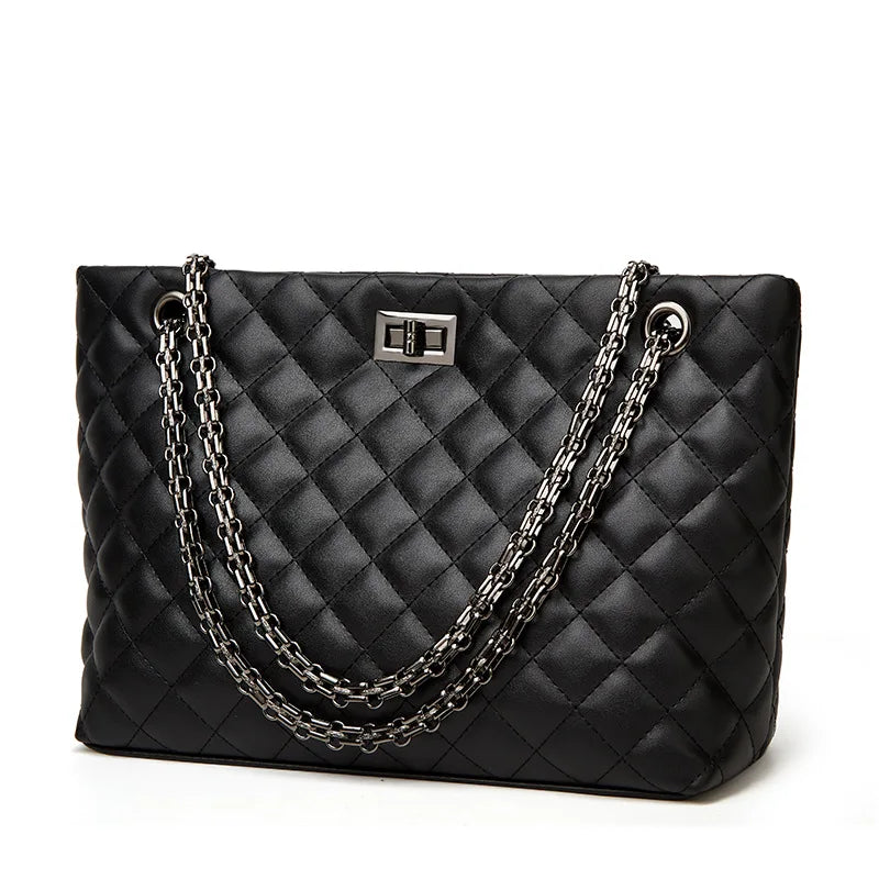 Black quilted handbag with chain detail on a white background