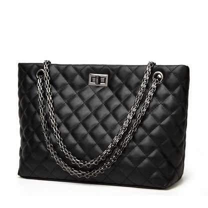 Black quilted handbag with chain detail on a white background