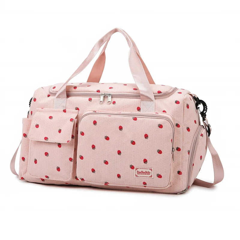 Pink polka dot bag with a visible brand logo on a white background