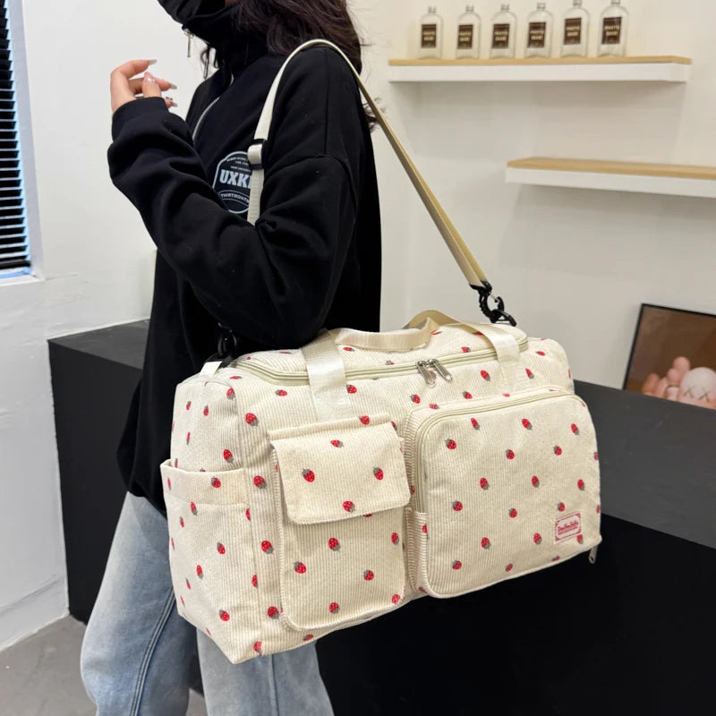 Person holding a large polka dot bag in an indoor setting