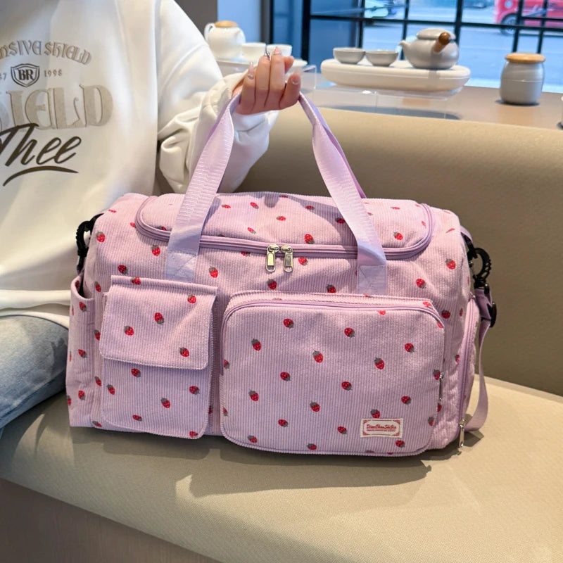 Pink polka dot bag held by a person in a casual setting
