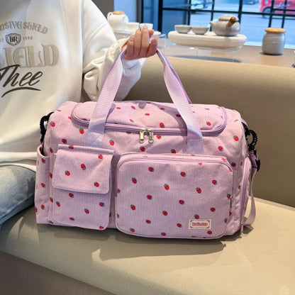 Pink polka dot bag held by a person in a casual setting
