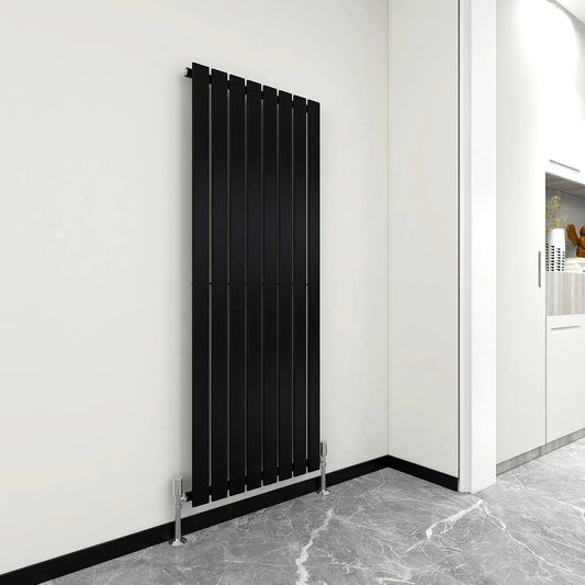 Black vertical radiator against a white wall in a modern interior setting.