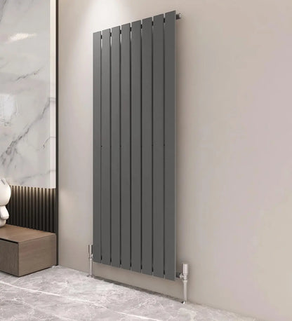 Modern vertical radiator on a wall with a marble and wooden cabinet in the background