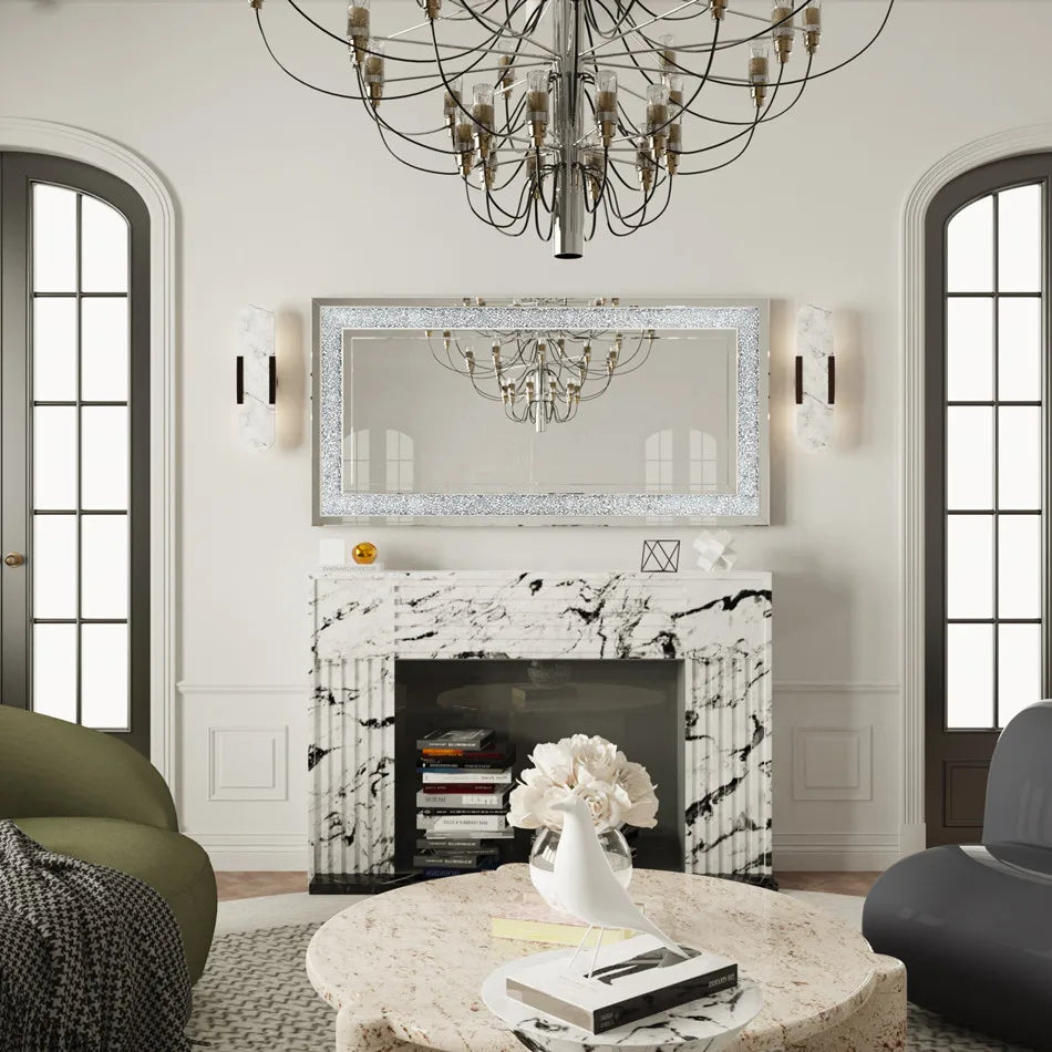 Living room with marble fireplace, chandelier, and decorative mirror.