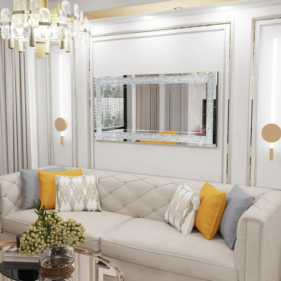 Modern living room with a gray sofa, decorative pillows, and a large mirror.