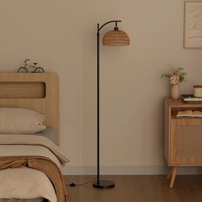 Modern bedroom with a floor lamp, bed, and side table.