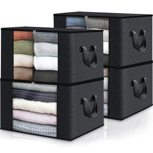 Black storage cubes with handles filled with folded clothes on a white background