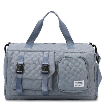 Gray quilted duffel bag with straps on a white background