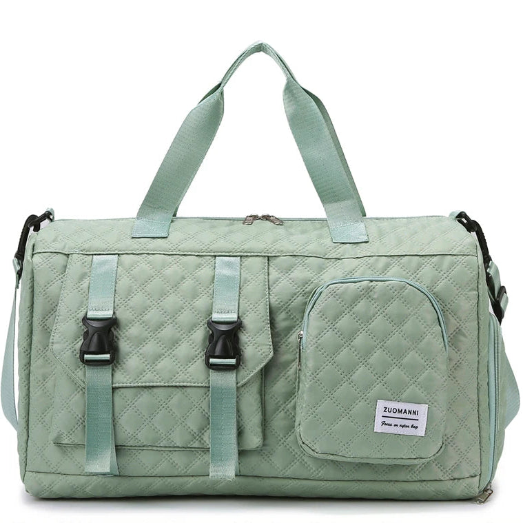 Green quilted duffel bag with straps on a white background