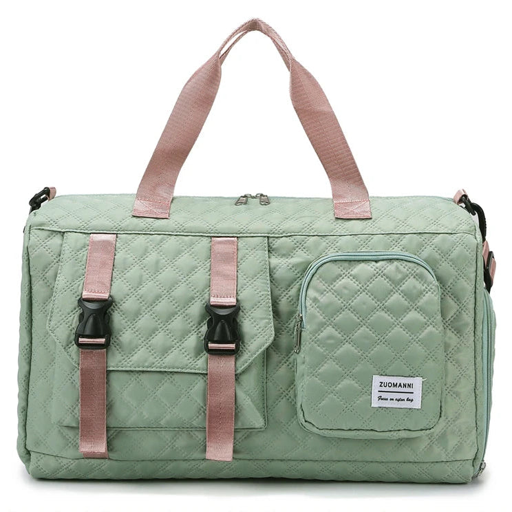 Green quilted duffel bag with pink straps on a white background