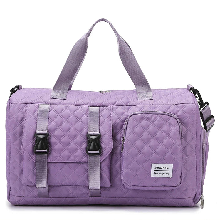 Purple quilted duffel bag with straps on a white background