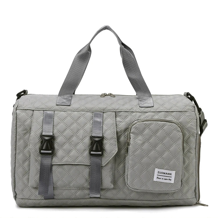 Gray duffel bag with multiple straps and a visible brand label on a white background