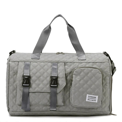 Gray duffel bag with multiple straps and a visible brand label on a white background
