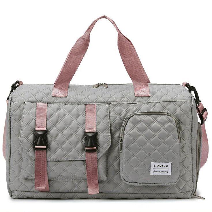 Gray quilted duffel bag with pink straps on a white background
