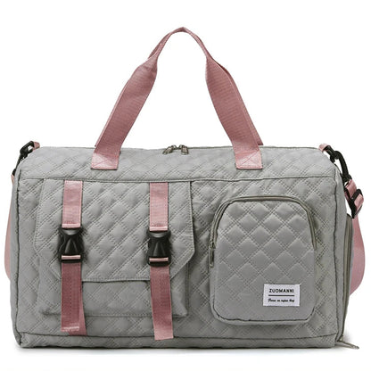 Gray quilted duffel bag with pink straps on a white background
