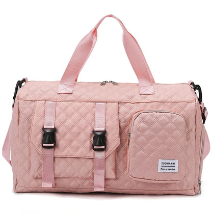 Pink quilted duffel bag with black zippers on a white background