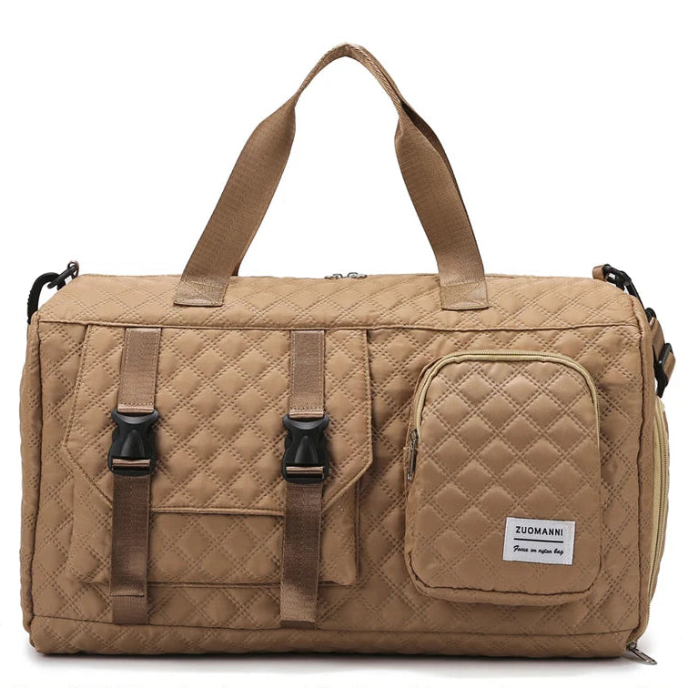 Beige quilted duffel bag with multiple straps on a white background