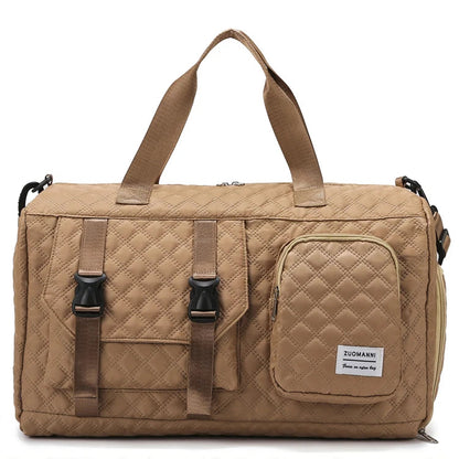 Beige quilted duffel bag with multiple straps on a white background