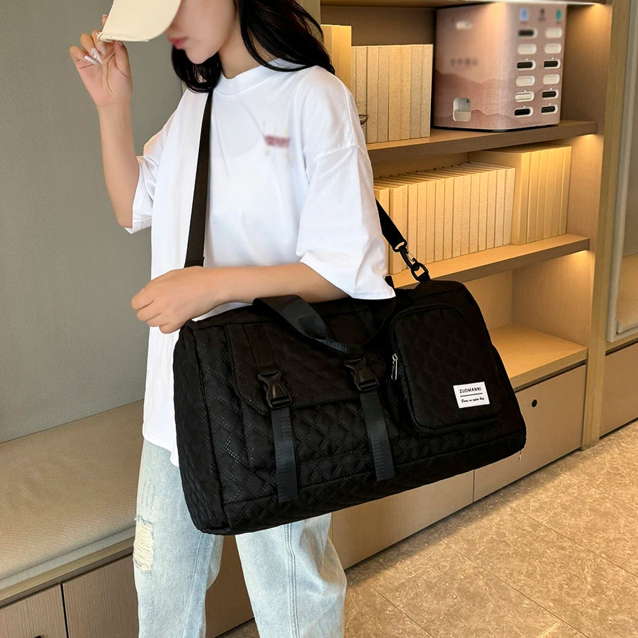 Person holding a black bag in an indoor setting