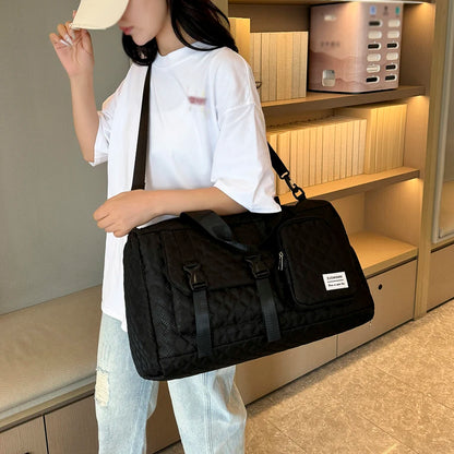 Person holding a black bag in an indoor setting
