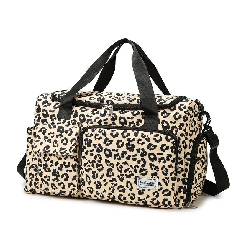 Leopard print duffel bag with black straps on a white background