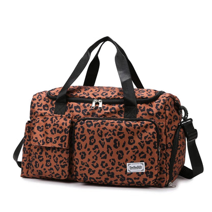 Leopard print duffel bag with black straps on a white background