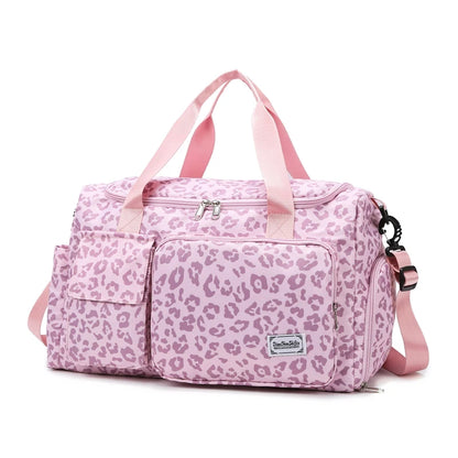Pink leopard print duffel bag with pink straps on a white background