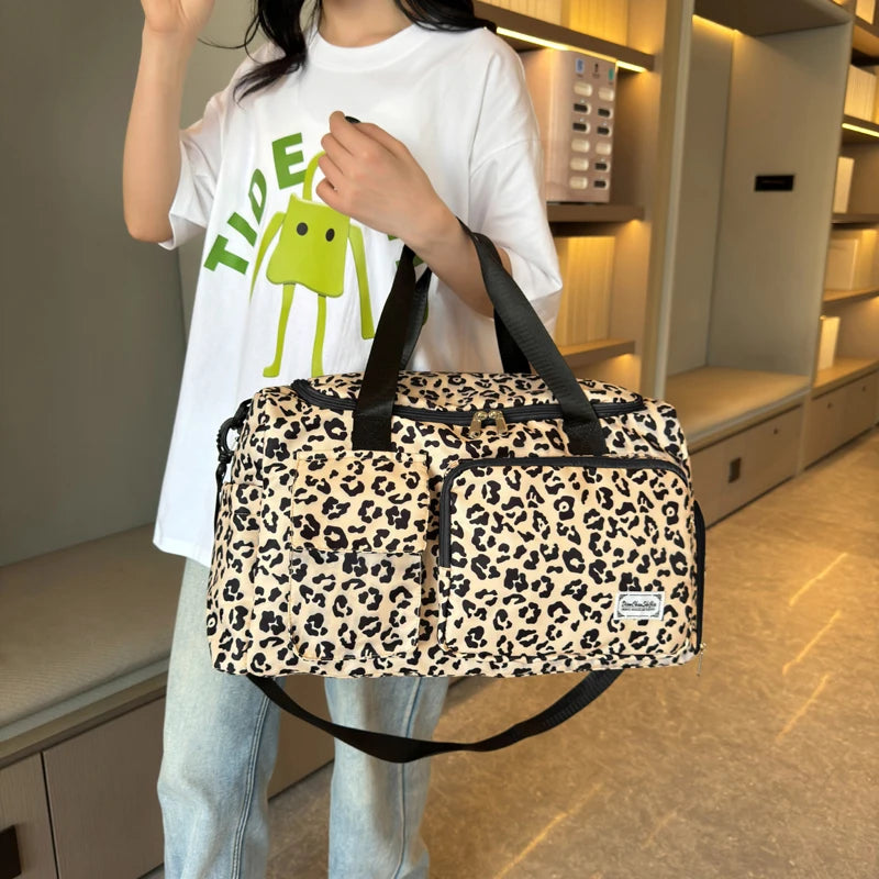 Person holding a leopard print bag in an indoor setting