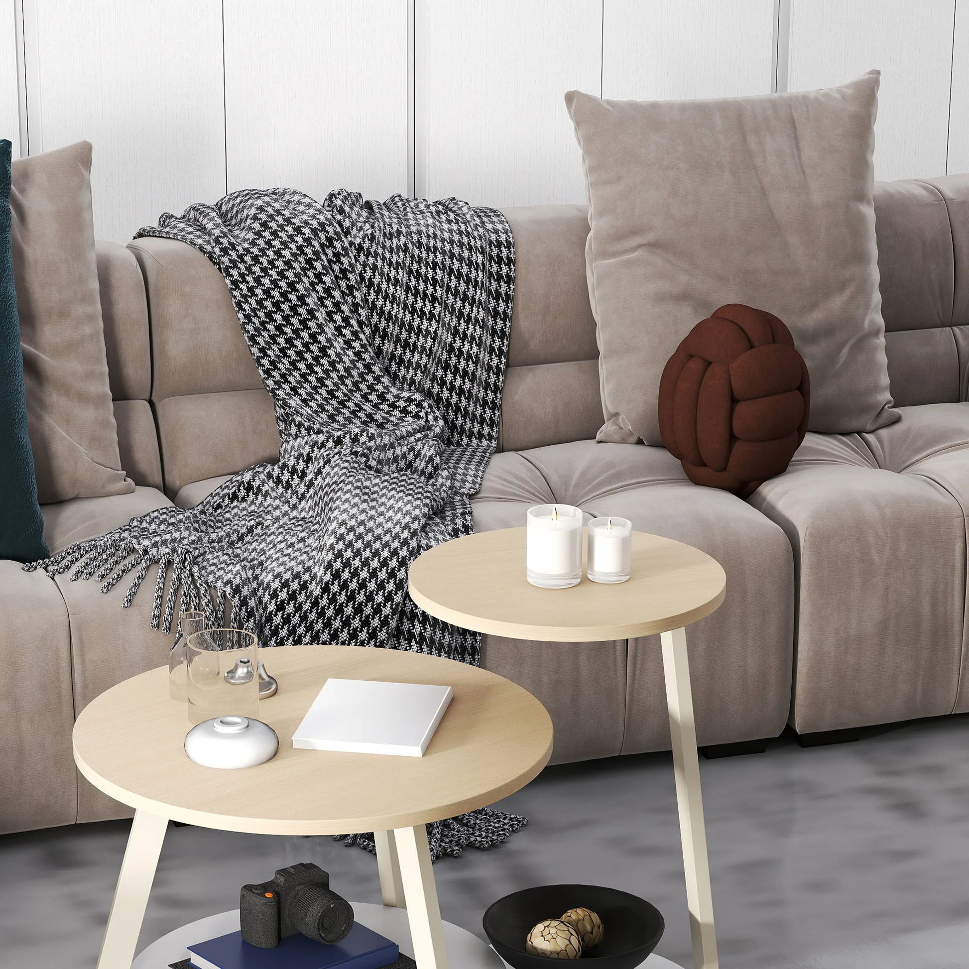 Beige sectional sofa with decorative pillows and a blanket, accompanied by two wooden side tables.